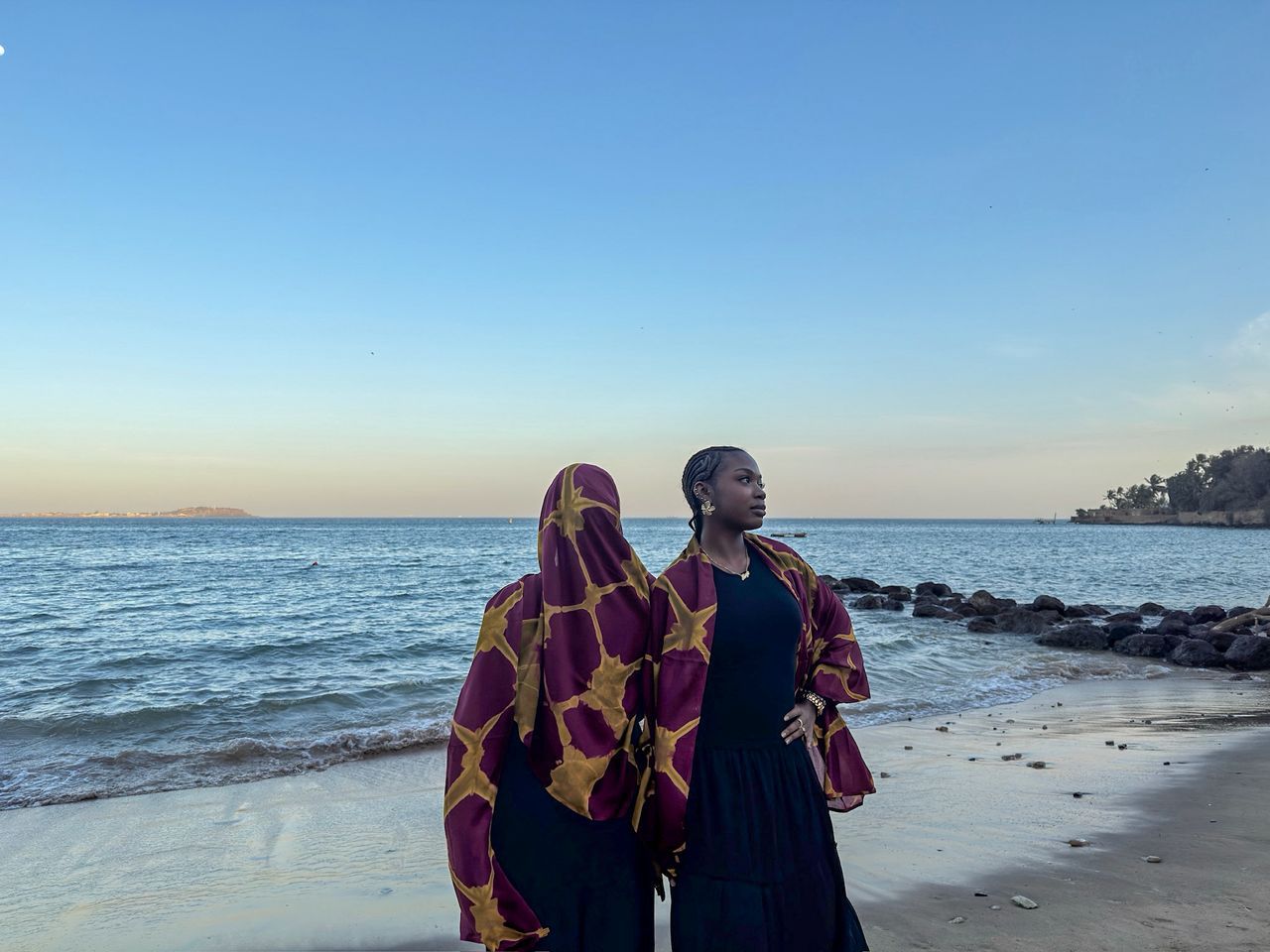 Two women in Sahrawiyat at the shore
